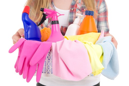 Person blotting a spill during routine rug cleaning maintenance