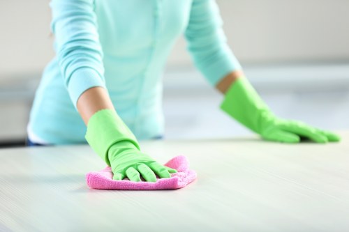 Professional office cleaning team sanitizing workplace surfaces