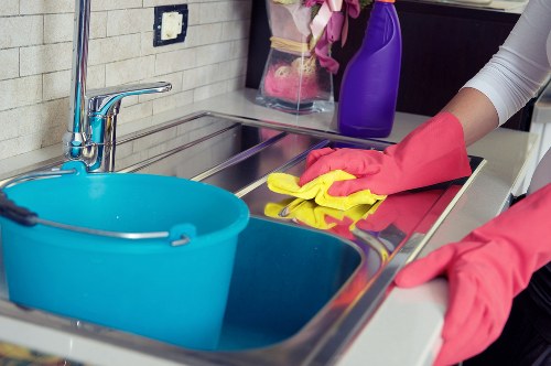 Detailed cleaning of kitchen cabinets and surfaces before moving in